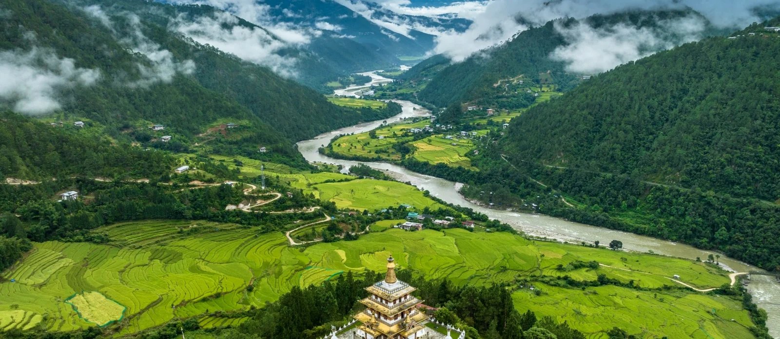 Bhutan valley with river, forests, farmland and temple