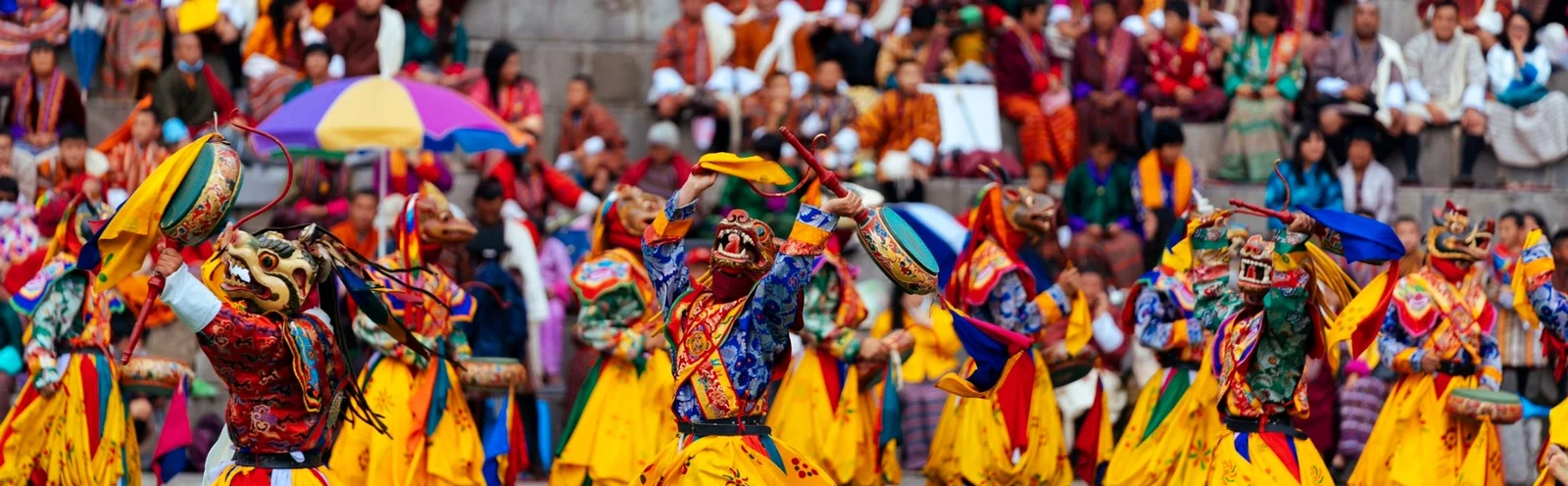 Colourful masked dancers performing at a Bhutan festival